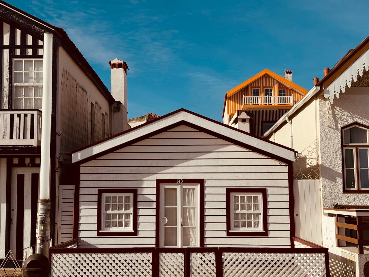 A row of picturesque wooden houses in Gafanha da Encarnação, Portugal.